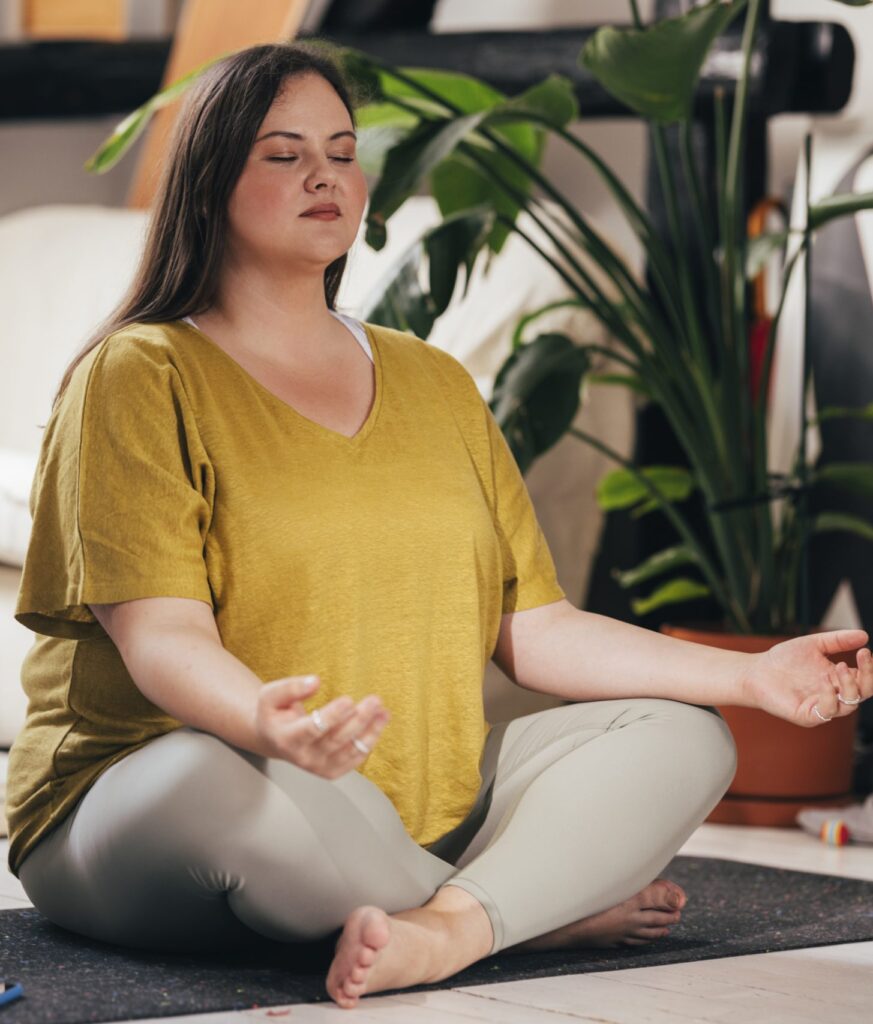 Woman sat on floor doing yoga